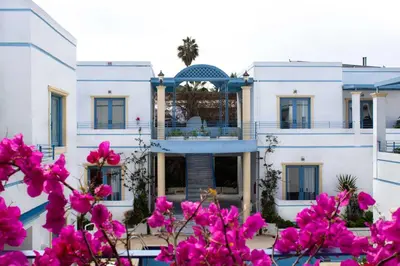a building with pink flowers in front of it at Blue Calm in Daratso