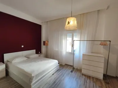 a bedroom with a white bed and a window at Superior Apartment Near Beach in Chania Town