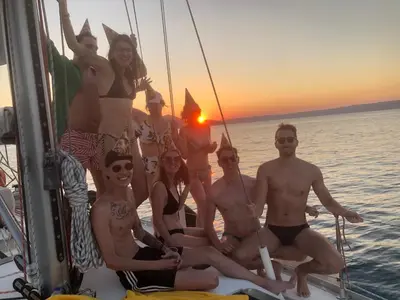 a group of people posing for a picture on a boat at Perseus Sailing Cruises in Souda