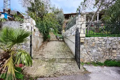 a stone wall with a gate and a stone path at Seaside House in Chania Town