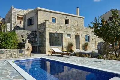 a house with a swimming pool in front of a house at Villa Iro - Private Pool & Tranquility in Káïna