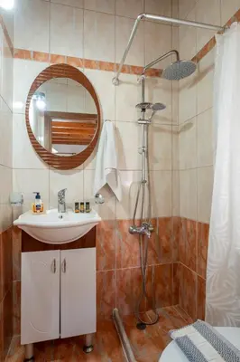 a bathroom with a sink and a shower with a mirror at Villa Kamaraki in Patellárion