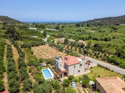 an aerial view of a house with a swimming pool at Villa Kamaraki in Patellárion