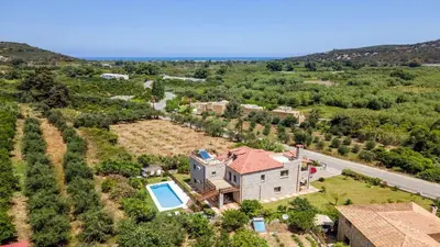 an aerial view of a house with a swimming pool at Villa Kamaraki in Patellárion