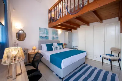 a bedroom with a bed and a staircase at GreenView Chania Center Luxury Suite in Chania Town