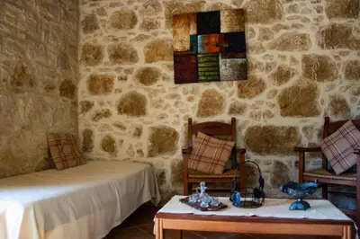a room with a bed and a table and chairs at Villa Antonia in Gramvousá