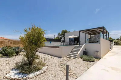 a house with a swimming pool in a yard at Menta Villa by Vintage Travel in Tavronitis
