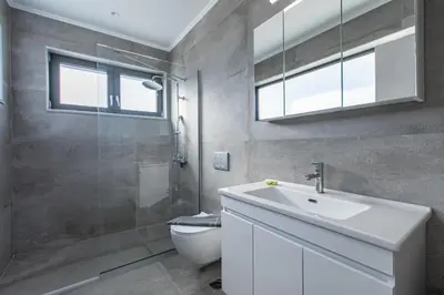 a bathroom with a toilet and a sink and a shower at Myrtle Villa by Vintage Travel in Tavronitis