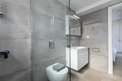 a bathroom with a toilet and a sink at Sage Villa by Vintage Travel in Tavronitis