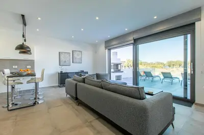 a living room with a couch and a table at Sage Villa by Vintage Travel in Tavronitis