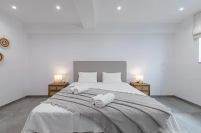 a bedroom with a large bed with towels on it at Diktamos Villa by Vintage Travel in Tavronitis