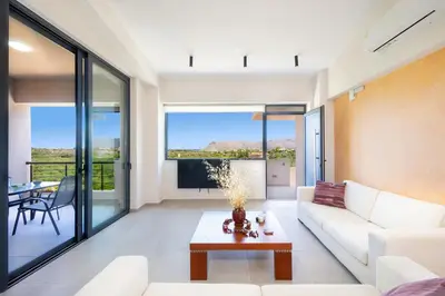 a living room with a couch and a table at Didas Serenity Breeze in Kounoupidhianá