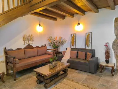 a living room with two couches and a coffee table at Achlades The Mountain Paradise Villas - Maisonette with pool and amazing view! in Aletrouvárion