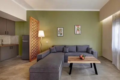a living room with a couch and a table at Callista City Living III in Chania Town