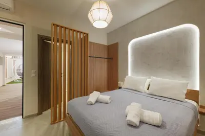 a bedroom with two white towels on a bed at Callista City Living III in Chania Town