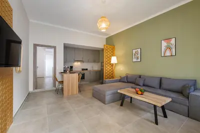 a living room with a couch and a table at Callista City Living III in Chania Town
