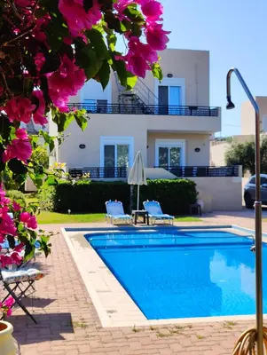 a villa with a swimming pool in front of a house at Bellavista Gardens Skoutelonas in Skoutelónas