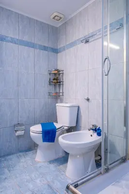 a bathroom with a toilet and a sink and a shower at Haris home in Daratso