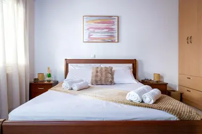 a bedroom with a bed with towels on it at Haris home in Daratso