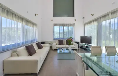 a living room with a couch and a glass table at Gramvousa Villas in Kissamos
