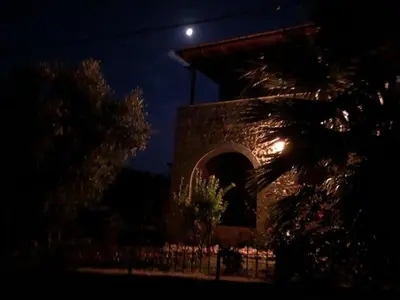 a building at night with the moon in the sky at Villa Aris in Crete with private pool en private parking! in Neo Chorio