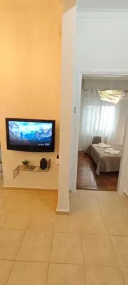 a living room with a flat screen tv on a wall at Color Living in Chania Town