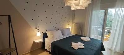 a bedroom with a bed with two towels on it at Color Living in Chania Town