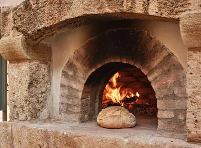 a brick oven with a loaf of bread in it at Studios Stylianos in Kounoupítsa