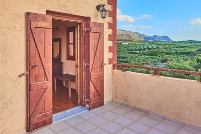 an open door to a balcony with a view at Villa Evenos with private pool in Elafonisi
