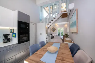 a kitchen and dining room with a table and chairs at Villa Mareli - Beachside Villa with Heated Pool in Almirida