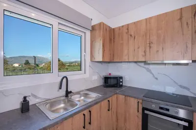 a kitchen with a sink and a window at Villa Pervana- Private pool - Close to the Beach in Arménoi