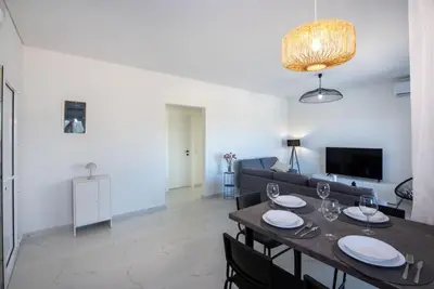 a living room with a table and a couch at Villa Pervana- Private pool - Close to the Beach in Arménoi