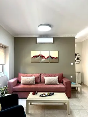 a living room with a red couch and a table at Nerina Home Chania in Chania Town