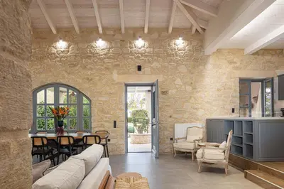 a living room with a couch and a table at Artemis Apollonas Villa I Luxury Escape with Pool in Káïna