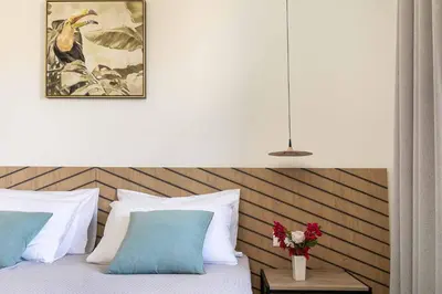 a bedroom with a bed with a vase of flowers at Villa Eva Chania in Neo Chorio