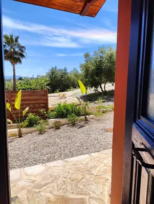 a view of a garden from a house window at Bellavista Panorama Darmarochori in Darmarochori