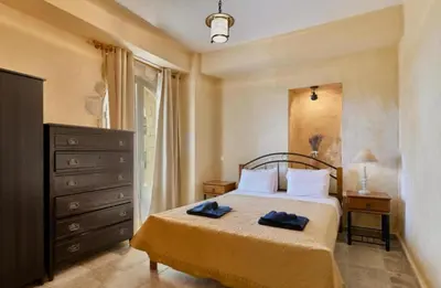 a bedroom with a bed with two towels on it at Elaiona Country Home in Xamoudhokhórion