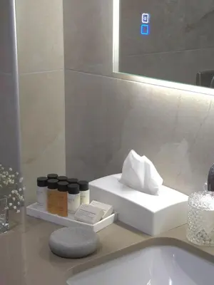 a bathroom counter with a sink and a mirror at Breeze Apartment in Chania Town