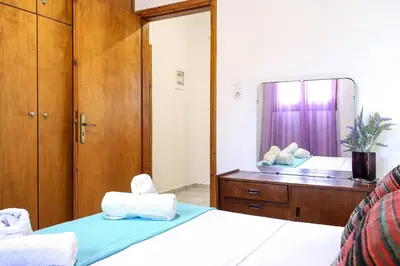 a bedroom with a bed and a large mirror at Alkis Hideaway in Kissamos