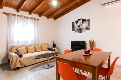 a living room with a couch and a table at Alkis Hideaway in Kissamos