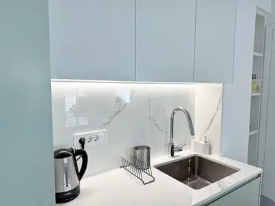 a kitchen with a sink and a coffee maker on a counter at Azure Loft - 3min walk to beach, 10min to Old Town in Chania Town