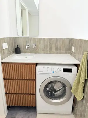 a kitchen with a washing machine and a sink at Azure Loft - 3min walk to beach, 10min to Old Town in Chania Town
