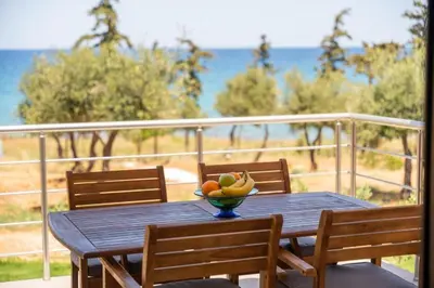a table with a bowl of fruit on a balcony at Terra Blue Suites - Nefeli in Kalyves