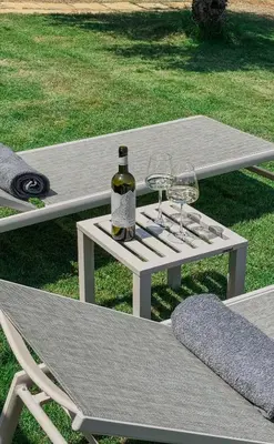 a white picnic table with two glasses and a bottle of wine at Terra Blue Suites - Nefeli in Kalyves