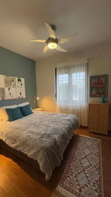 a bedroom with a bed and a ceiling fan at La Casa di Corina in Kato Daratso