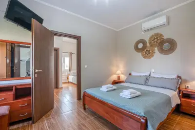 a bedroom with a bed with two towels on it at Margie's Apartments in Kissamos