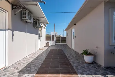 an alley between two buildings with a dog on the side at Margie's Apartments in Kissamos