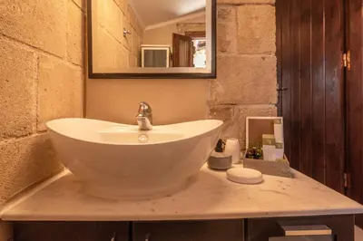 a bathroom with a sink and a mirror at Villa Dimmare by PosarelliVillas in Kissamos
