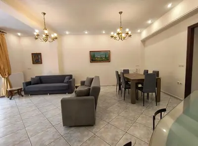 a living room with a couch and a table and chairs at Angie A1 close to the beach by 8essentially in Chania Town
