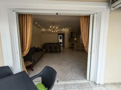 a living room with a couch and a dining room at Angie A1 close to the beach by 8essentially in Chania Town